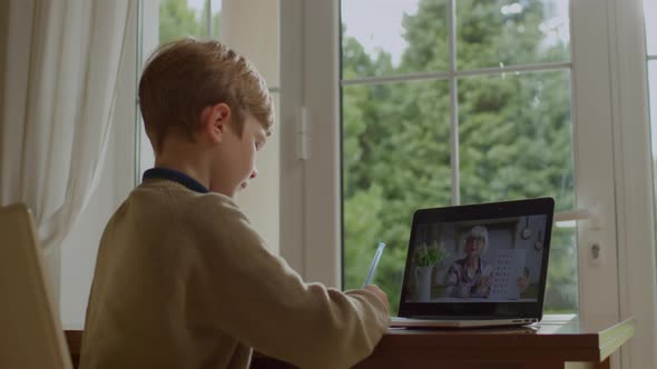 School Kid Studying Math with Senior Teacher Online Using Laptop for Distance Learning at Home