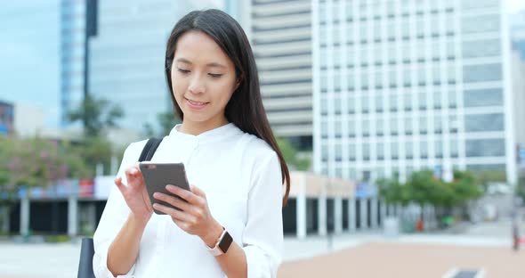 Woman use of smart phone in city