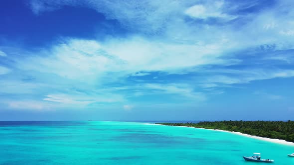 Aerial drone shot travel of relaxing shore beach trip by clear water and white sandy background of a