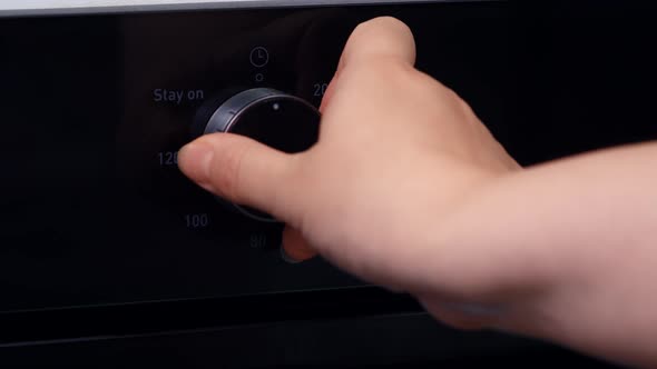 Woman Sets Cooking Time Oven