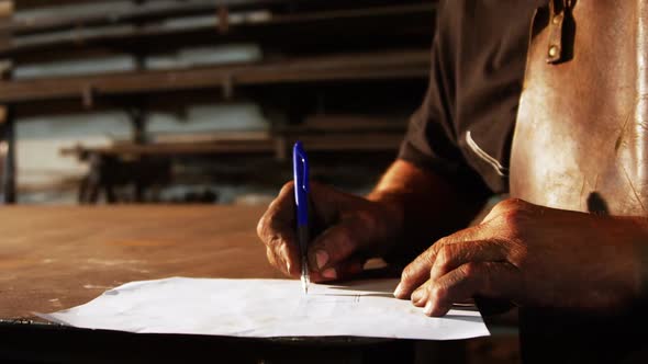 Welder working on blueprint