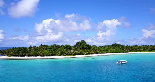 Tropical aerial tourism shot of a paradise sunny white sand beach and aqua blue water background in 