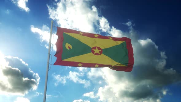 Flag of Grenada Waving at Wind Against Beautiful Blue Sky