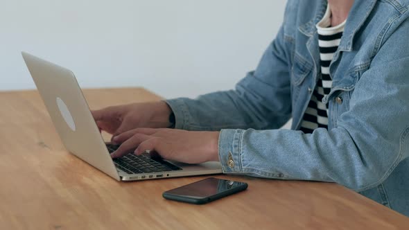 Man Works at the Laptop in Office