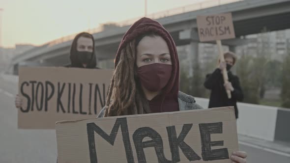 People with Signs Protesting on Highway