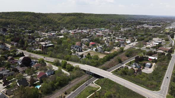 Aerial view showing bridge and intersection in Grimsby Village during sunny day in front of green hi