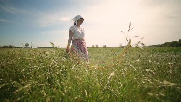 A Farmer Woman Goes to the Pasture with Buckets to Water or Milk Her Cattle