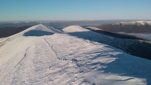 Drone Flying Over Snow Covered Mountain Ridge