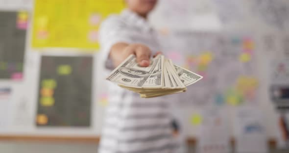 Hand man giving cash money to businessman