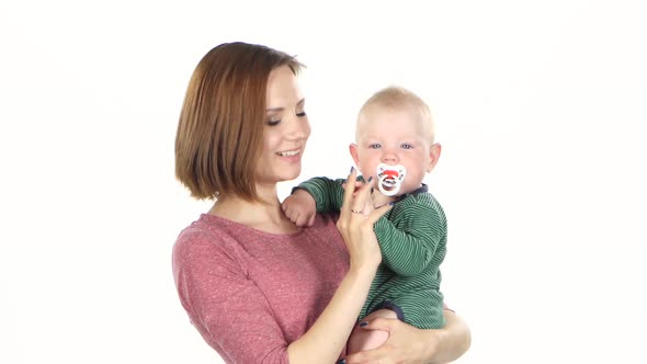 Baby in Mother Arms. White