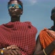 Young Masai Tribe Members in Red Dresses and Sunglasses Standing on Sand Beach of Indian Ocean - VideoHive Item for Sale