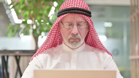 Old Arab Businessman Working on Laptop 