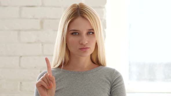 Young Woman Waving Finger to Refuse