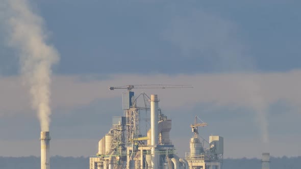 Timelapse of Cement Plant with High Factory Structure and Tower Cranes at Industrial Production Area