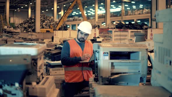 Male Employee Is Examining Defective Office Machines