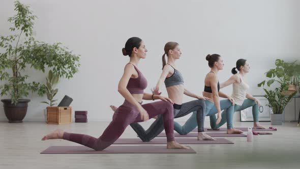 Four Female Yogi Having Indoor Yoga Training