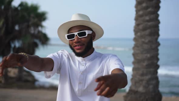 Positive Handsome African American Confident Man Dancing and Singing in Slow Motion at Summer Resort