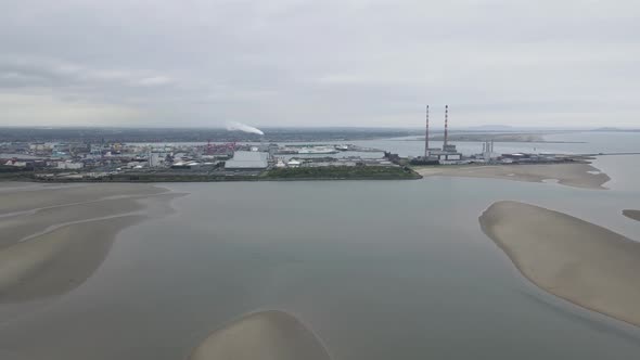 Sandymount Strand Beach And Poolbeg Power Plants In Dublin, Ireland On A Cloudy Day. wide aerial sho