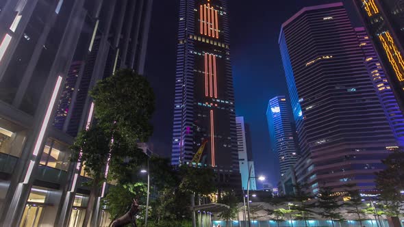 Night View Hyperlapse of Modern City in Park with Fountain and Skyscrapers Around