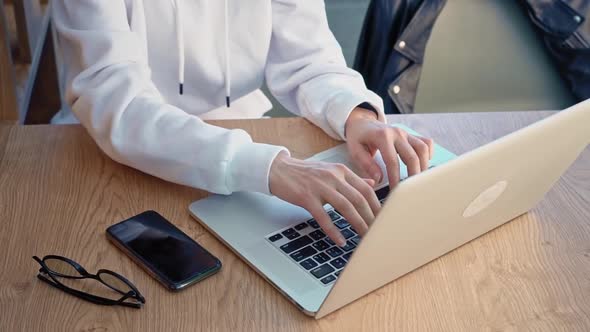 Portrait of a Young Caucasian Female Freelancer Using a Laptop to Work at a Distance Sitting in a