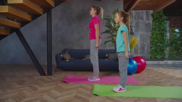 Active Fitness Family Doing Reverse Lunges Indoors