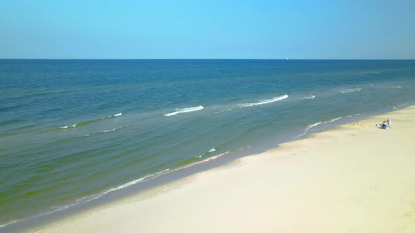 Few people on white-sand Beach in Osetnik, Poland, during the Covid-19 pandemic early autumn 2020, D