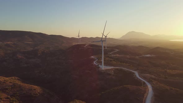 Windmills Farm for Power Production on Beautiful Landscape at Sunrise