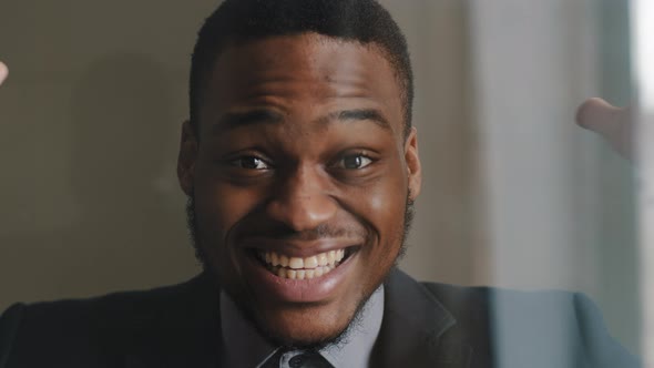 Closeup of Enthusiastic Darkhaired Male Face Portrait of Afroamerican Business Man in Suit Opens