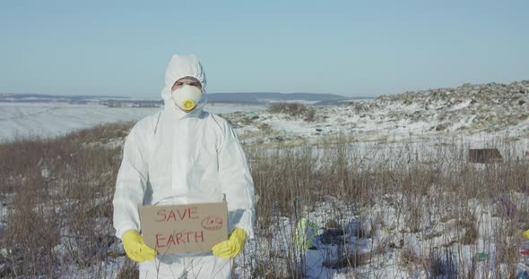 Man Wore in Protective Suit Show Protest Sign "Save Earth" at Plastic Pollution