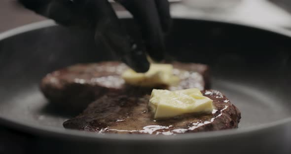 Slow Motion Man Rub Butter on Beef Steak on Nonstick Pan