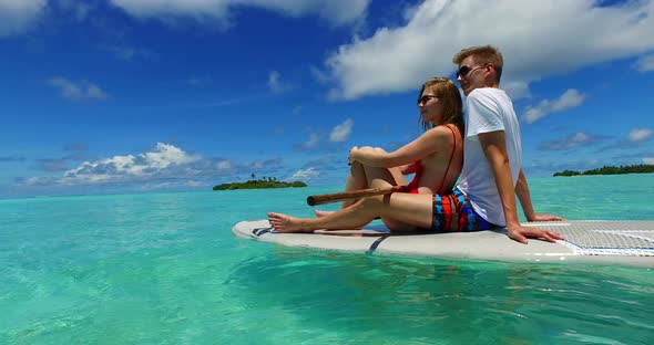 Romantic lady and man on honeymoon vacation enjoy luxury on beach on summer white sandy background 