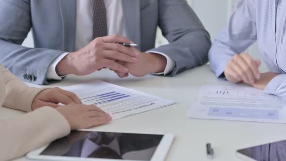 Close up of Hands of Business People Discussing Documents