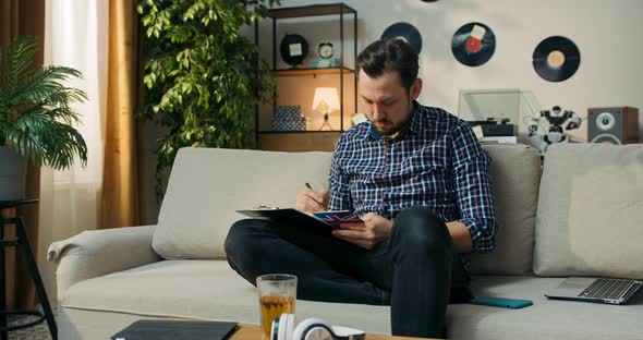 The Man is Sitting on Couch at Home Doing Homework for Extra English Classes Learning to Form