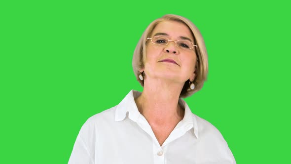 Happy Mature Woman in White Shirt Smiling on a Green Screen Chroma Key