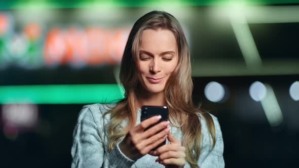 Happy Woman Chatting Use Smartphone at Night City Glow Bokeh