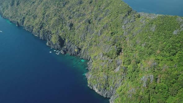 Green Rock Coast of Tropic Mountain Island at Ocean Bay Aerial