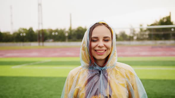 Young Woman in Raincoat in Rainy Weather