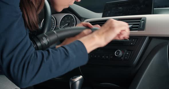 Young Woman Doing Vehicle Interior Detailing with Vacuum Cleaner