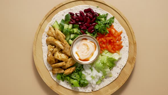 Fresh Ingredients for Preparing Tortilla with Vegetables Grilled Chicken and Sauce