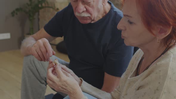 Woman Putting on Hearing Aid