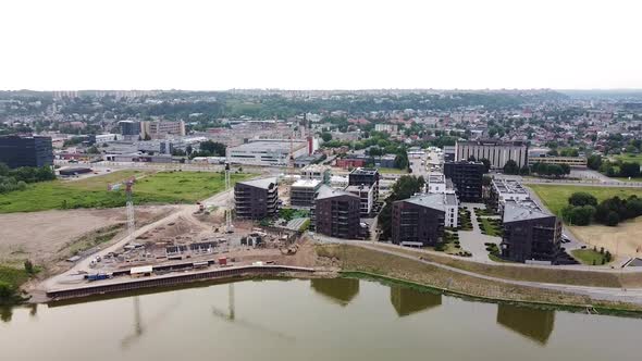 Building site of modern apartment building in Kaunas, Vilijampole district, aerial descend drone vie