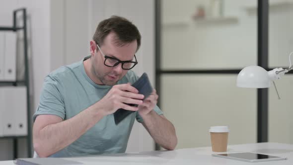 Young Man Checking Empty Wallet Work