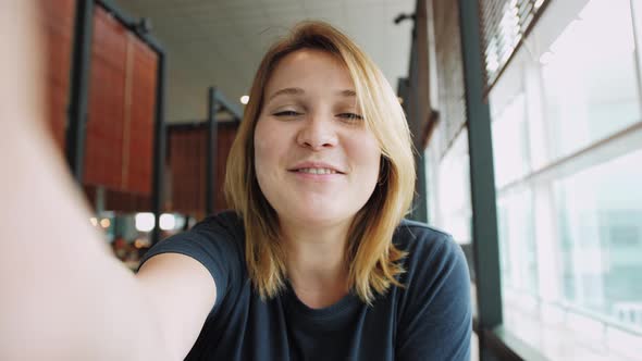 POV Video Call Portrait of Woman Tourist Talking to Friends or Colleagues While Waiting Flight in