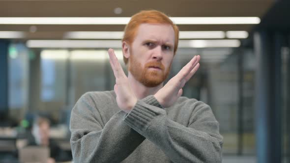 Portrait of Young Man Showing No Sign By Arms Crossed Denial