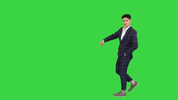 Man in Formal Business Suit Walks in and Dances Several Hip Hop Moves To Camera on a Green Screen