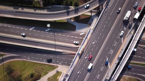 Aerial high drone flight over road traffic. Highway and overpass with cars and trucks, interchange,