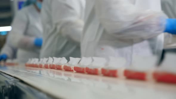 Packed Crab Sticks Are Getting Removed From the Belt By Factory Workers