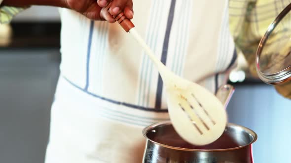 Senior man preparing food in kitchen