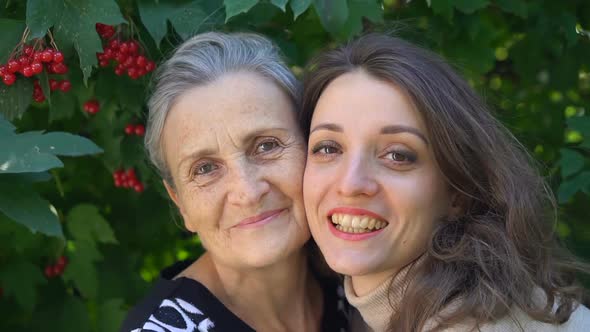 Happy Senior Mother in Eyeglasses is Hugging Her Adult Daughter the Women are Enjoying Together