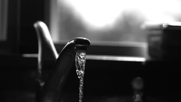 Water pouring from a faucet in ultra slow motion 1500fps on a reflective surface - WATER FAUCET 